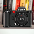 Leica SL3 camera with Field Made Co sticker label on a shelf with books in the background